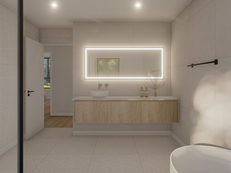 Modern bathroom featuring a floating vanity with vessel sink, LED backlit mirror, neutral tiled finishes, and a sleek freestanding bathtub.