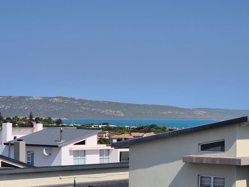 Elevated view overlooking the surrounding residential neighborhood with a scenic coastal and mountain backdrop.