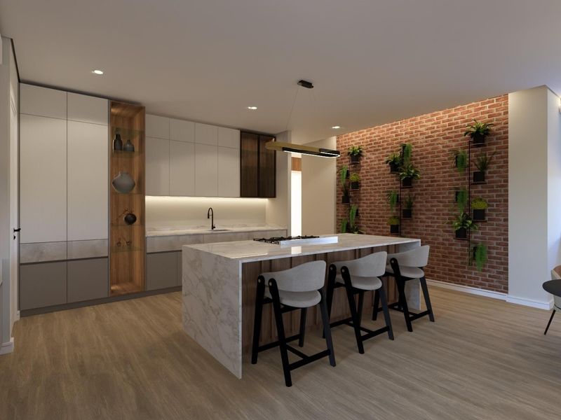 Modern kitchen featuring a large stone-topped island, sleek built-in cabinetry, and a striking exposed brick feature wall with integrated lighting.