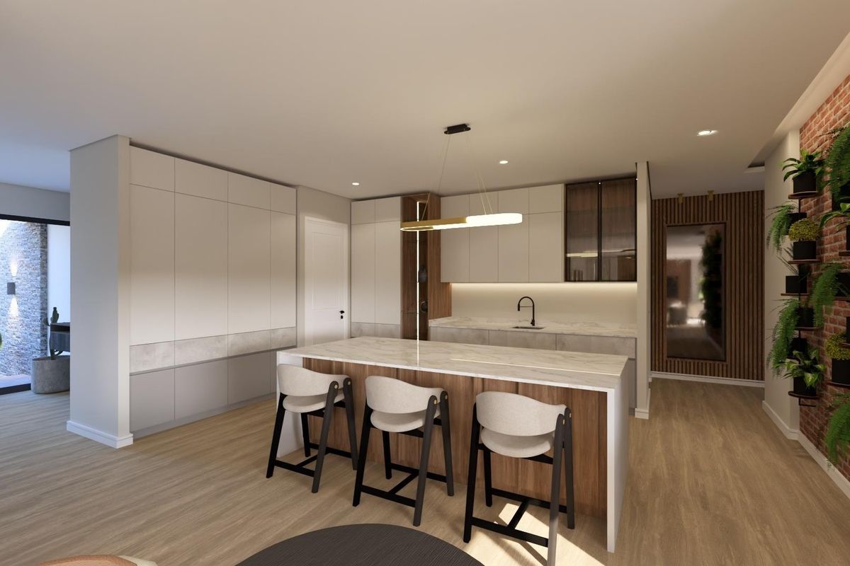 Modern kitchen featuring a central island with stone countertop, sleek built-in cabinetry, under-cabinet lighting, and a stylish exposed brick feature wall.