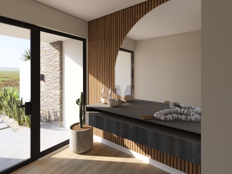 Modern entrance foyer featuring elegant slatted timber wall paneling, a built-in floating console, and an arched mirror with direct access to an outdoor patio.