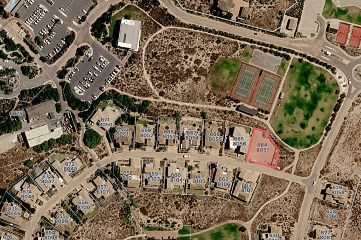 An aerial view of a residential estate showing the property plot highlighted in red, surrounded by local infrastructure, tennis courts, and road access.
