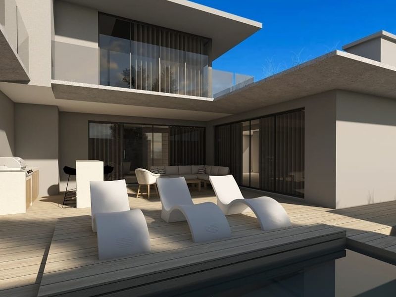 Modern outdoor pool area featuring timber decking, a built-in outdoor kitchen, and seamless access to the residence through large sliding glass doors.