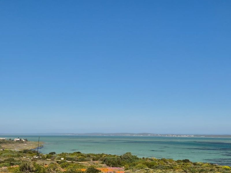 A scenic, elevated view overlooking the coastal landscape and turquoise waters, showcasing the natural beauty of the surrounding area.