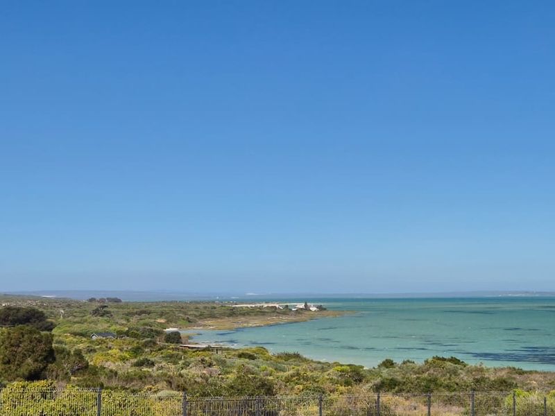 A scenic view of the coastal landscape and lagoon, showcasing the natural surroundings of the vacant residential property.