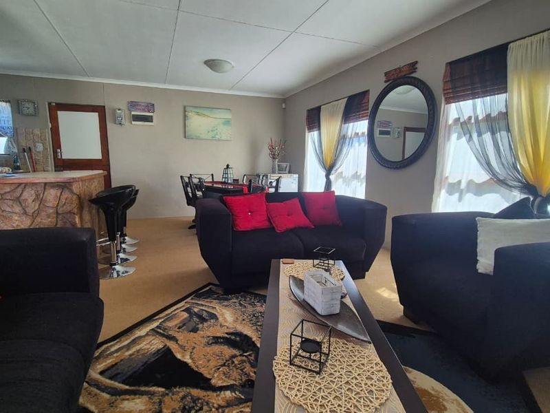 Open-plan living and dining area featuring a built-in breakfast bar and kitchen counter, offering a versatile layout for modern family living.