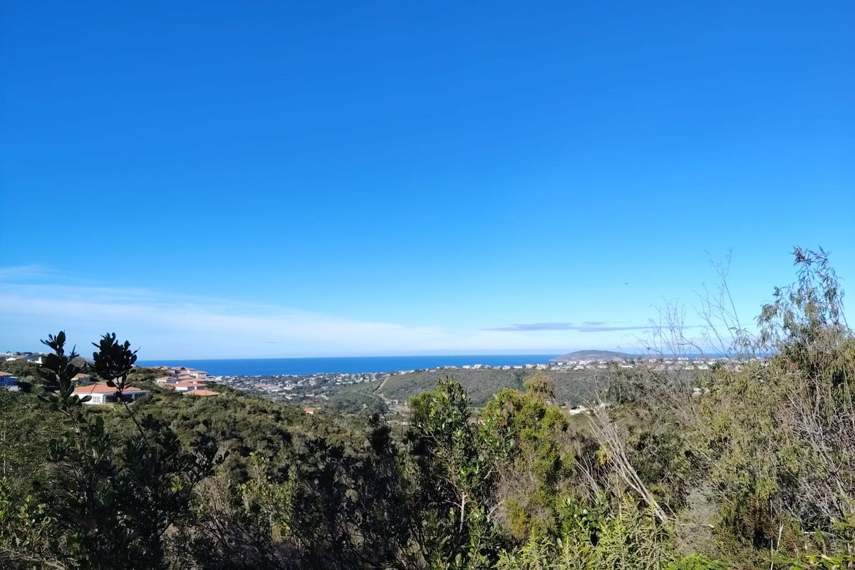 A scenic elevated view overlooking the surrounding landscape, coastal hills, and the distant ocean horizon.