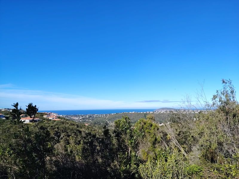A scenic elevated view overlooking the surrounding landscape, coastal hills, and the distant ocean horizon.