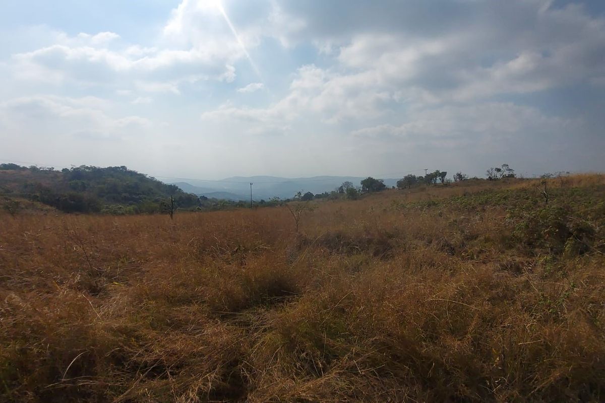 A wide-angle view of the expansive, undeveloped rural landscape and rolling hills surrounding the property.