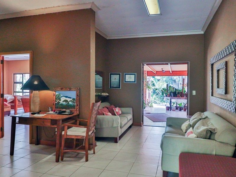 Spacious living area featuring tiled flooring, recessed lighting, and direct access to an outdoor patio space.
