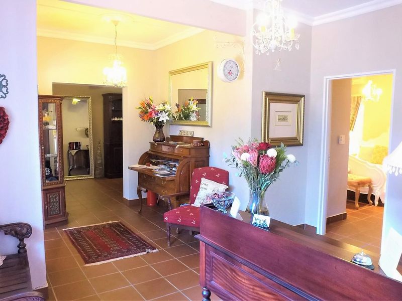 Welcoming entrance hall featuring tiled flooring, decorative ceiling cornices, and elegant crystal chandeliers, providing a warm and inviting transition into the home.