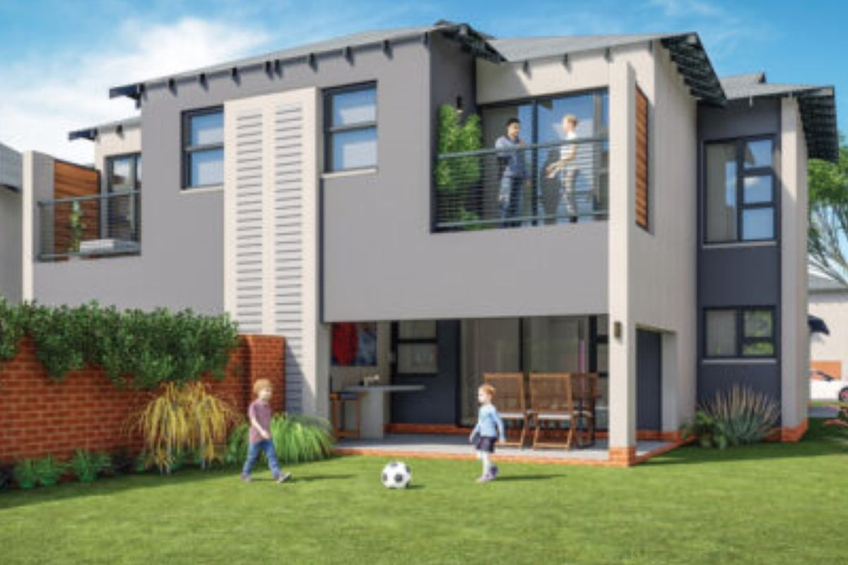 Rear view of a modern two-story townhouse featuring a private garden, covered patio, and an upper-level balcony with metal railings.