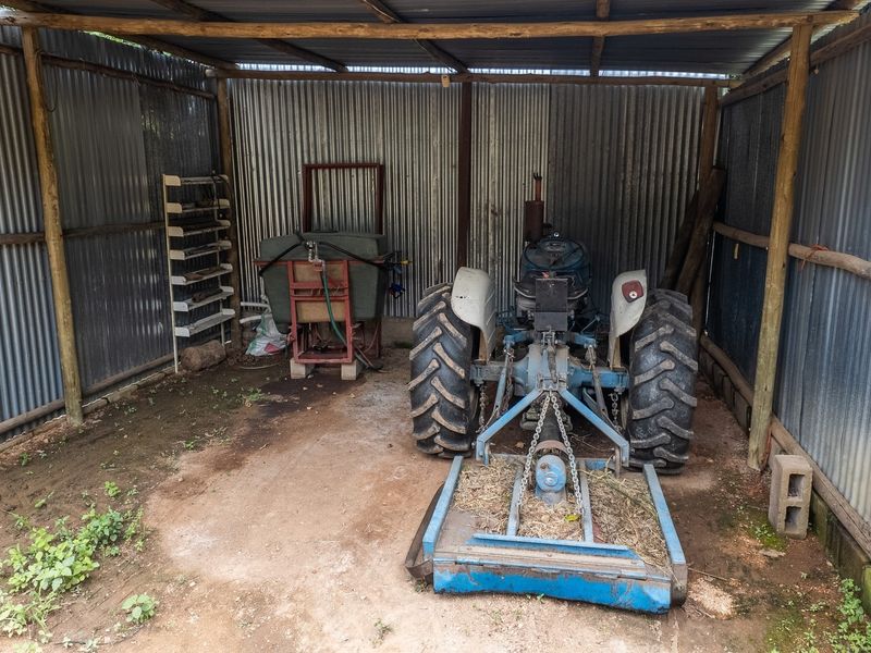 A basic utility shed featuring a timber frame and corrugated iron cladding, suitable for storage or farm equipment housing.