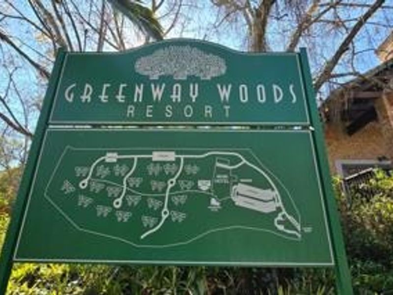 A directional signage board for Greenway Woods Resort displaying a site map and layout of the property.