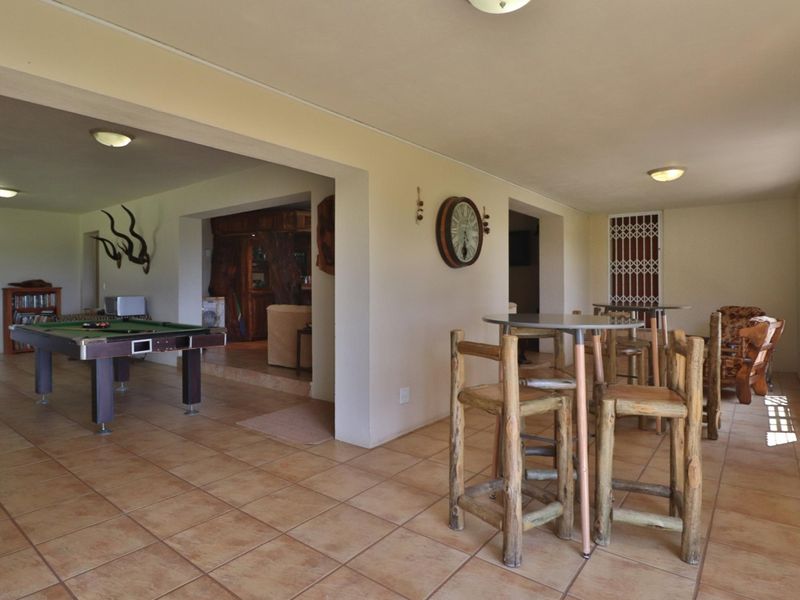 Spacious open-plan living area featuring ceramic floor tiles and recessed lighting, connecting multiple living zones with a functional layout.