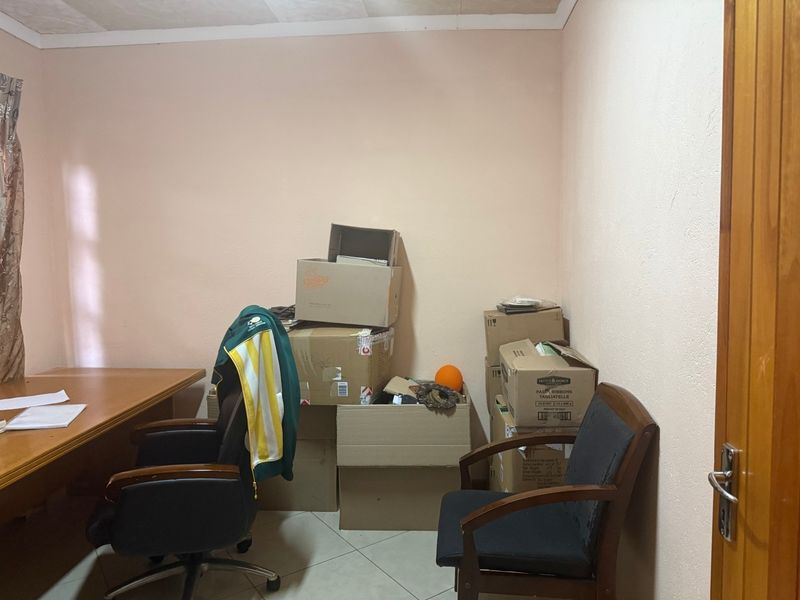 A functional office space featuring tiled flooring and neutral wall finishes, suitable for a home workspace or study area.