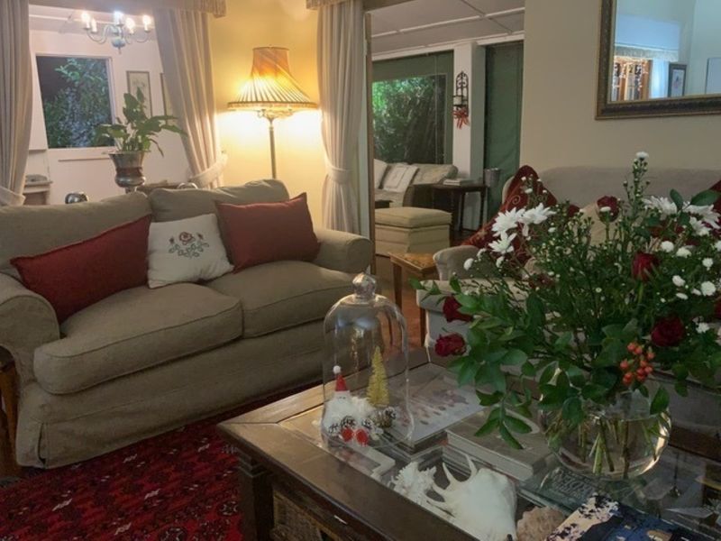 A cozy living room area featuring traditional interior finishes and connected access to an adjacent room.