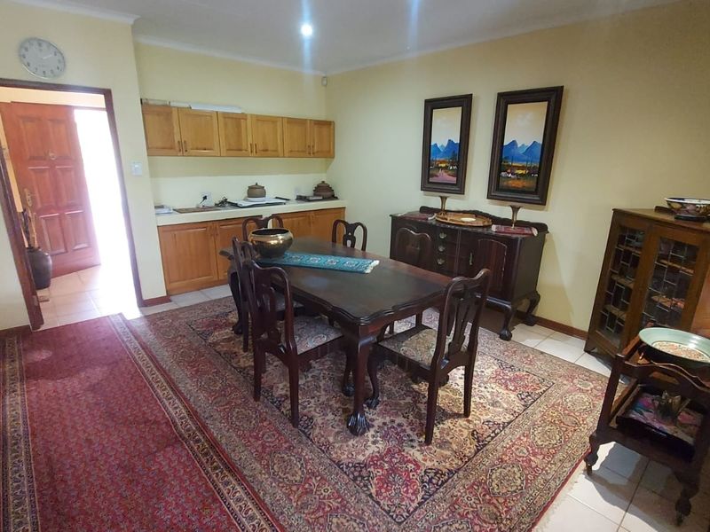 A dining room featuring built-in wooden cabinetry and tiled flooring, offering a functional space for meals and storage.
