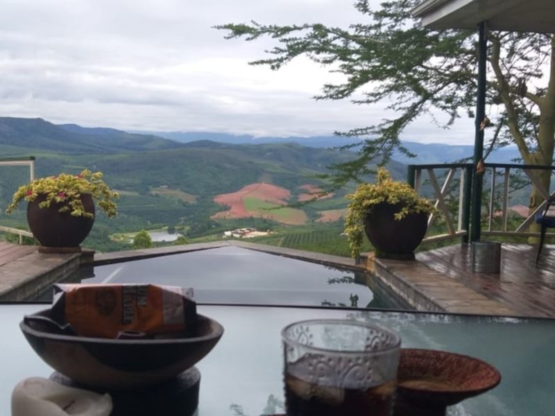An outdoor infinity pool area featuring wooden decking and expansive mountain views, providing a serene setting for relaxation.