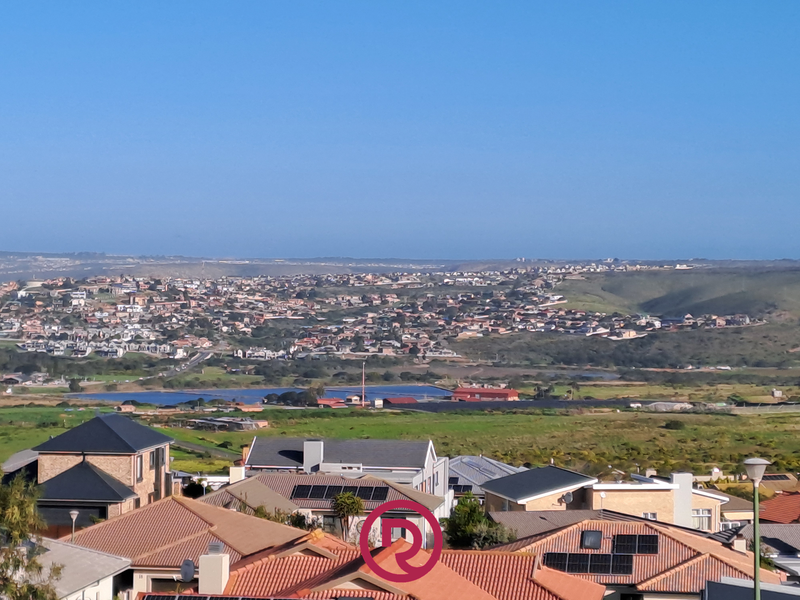 An elevated panoramic view overlooking a residential neighborhood and surrounding landscape, showcasing the property's scenic outlook.