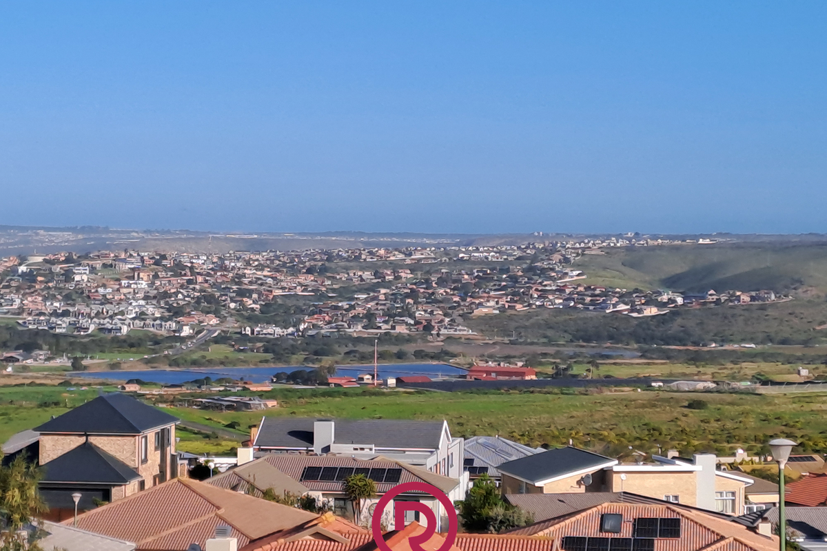 An elevated panoramic view overlooking a residential neighborhood and surrounding landscape, showcasing the property's scenic outlook.
