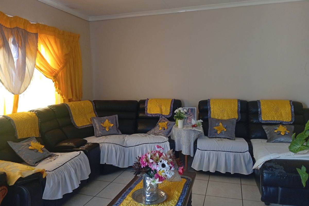 A living room featuring tiled flooring and standard wall finishes, providing a functional space for relaxation.