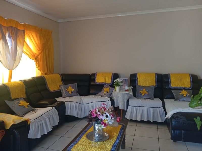 A living room featuring tiled flooring and standard wall finishes, providing a functional space for relaxation.