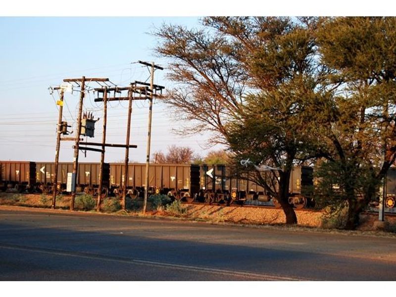 Street view of the commercial property frontage featuring adjacent railway infrastructure and utility poles.
