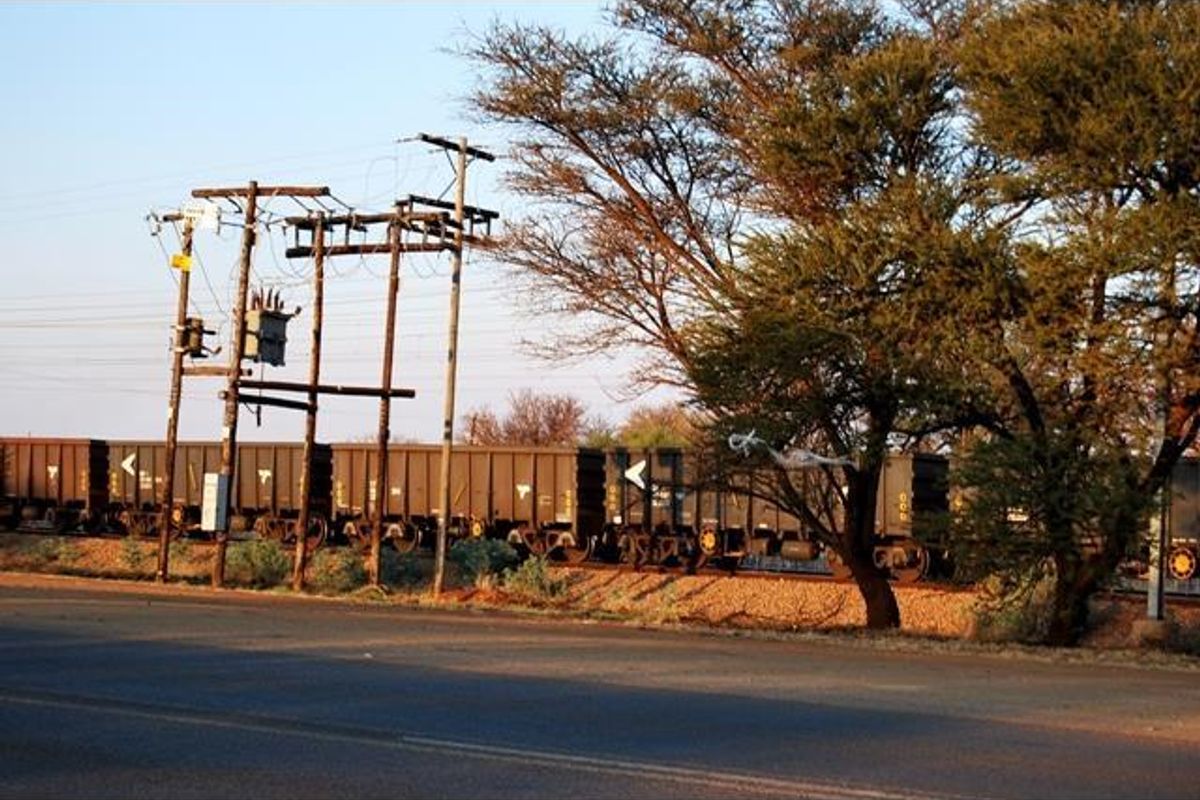 Street view of the commercial property frontage featuring adjacent railway infrastructure and utility poles.