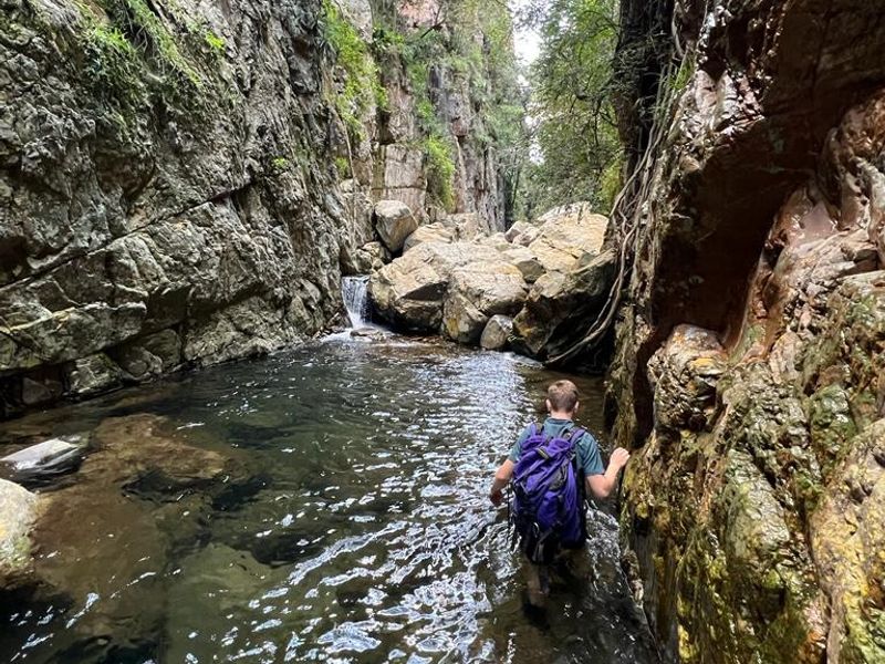 A natural rock gorge featuring a stream and rocky terrain, showcasing the natural landscape surrounding the property.