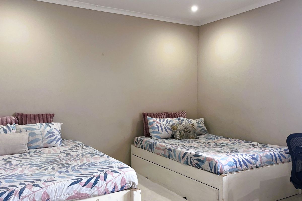 A bedroom featuring neutral wall tones, recessed ceiling lighting, and coving detail.