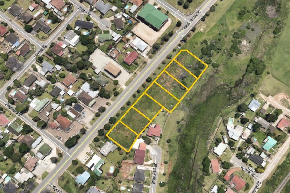 Aerial view of a vacant residential land parcel situated in a developed neighborhood, highlighting the plot boundaries and surrounding street access.