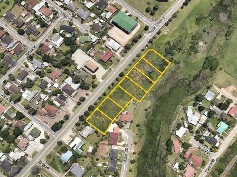 Aerial view of a vacant residential land parcel situated in a developed neighborhood, highlighting the plot boundaries and surrounding street access.