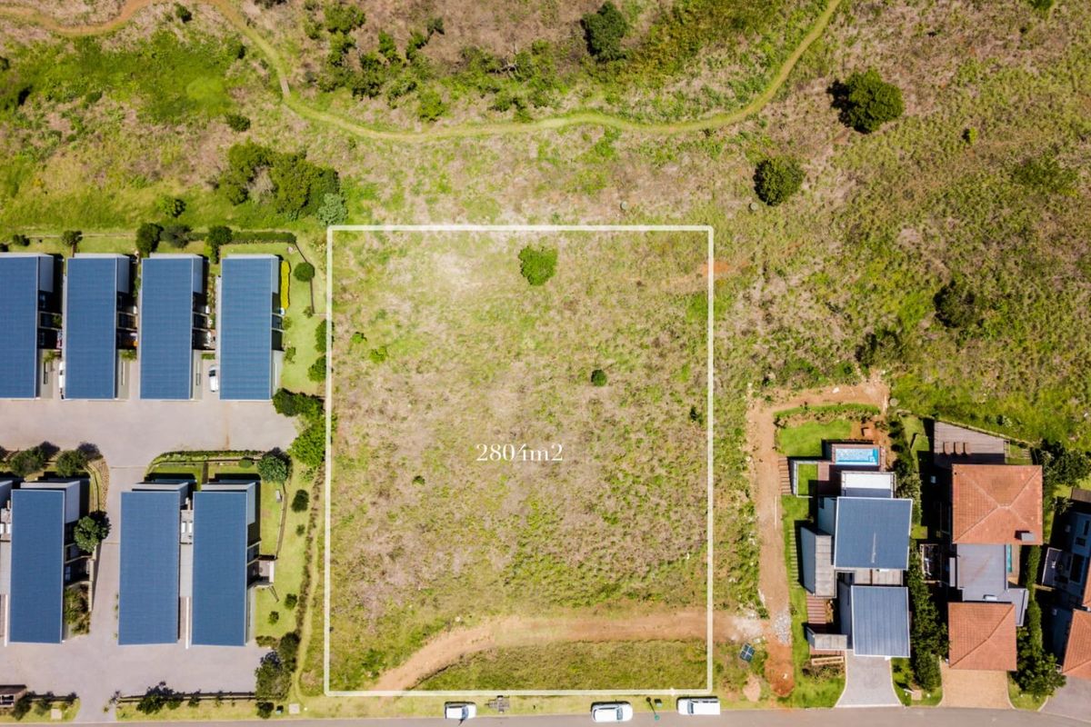 An aerial view of a 280m2 vacant residential plot situated within a developed estate, ready for new construction.