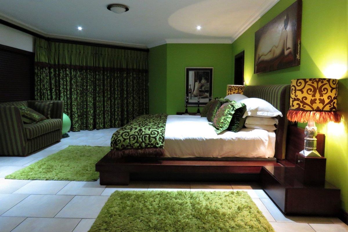 Spacious bedroom featuring tiled flooring, recessed lighting, and decorative crown molding, offering a generous layout for a primary suite.