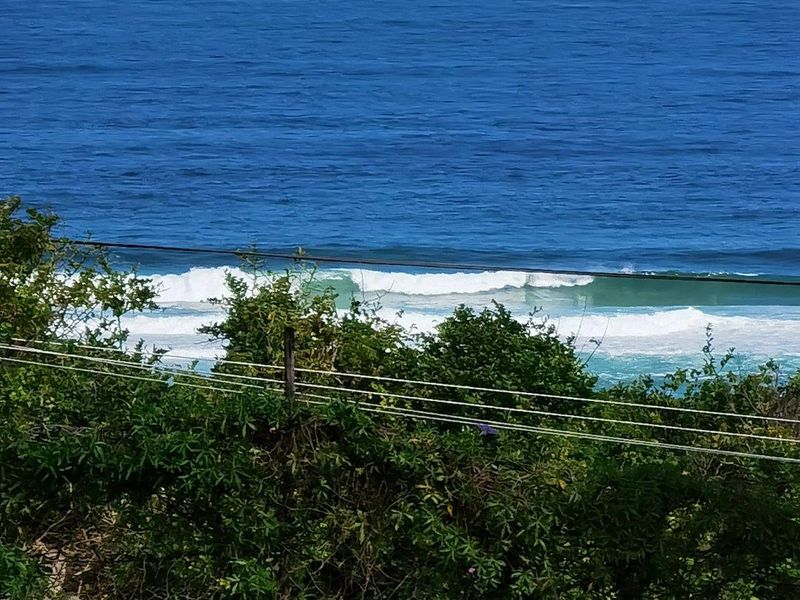 A scenic view of the ocean and breaking waves, captured from the property.