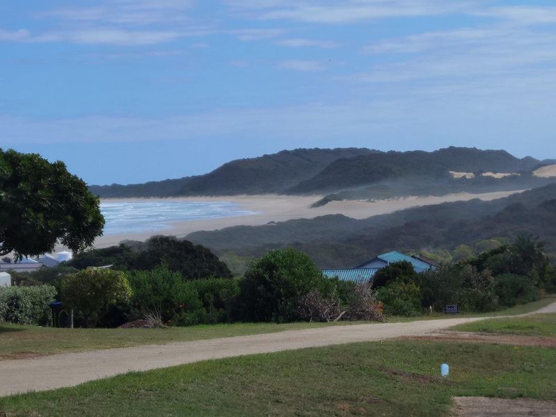 A scenic view of the coastline and surrounding landscape from the vacant residential property.