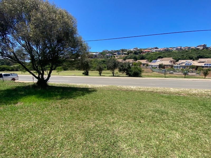 A view from the vacant residential land looking across the road towards the surrounding neighborhood and hillside landscape.