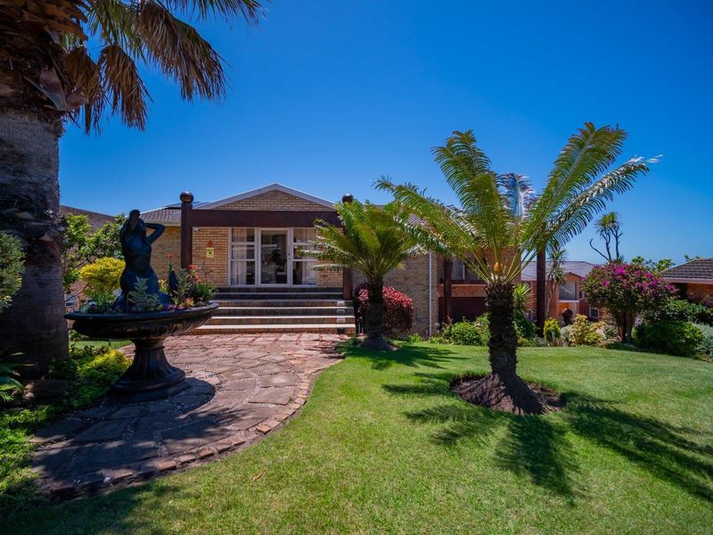 A well-maintained front exterior featuring a brick facade, stone paved pathway, landscaped garden, and a welcoming entrance with concrete steps.