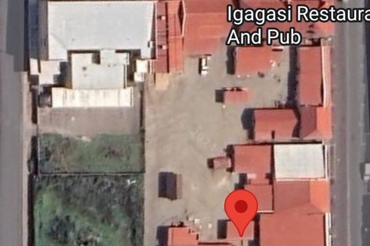 Aerial view of the property site showing the building layout, roof structure, and surrounding outdoor space.