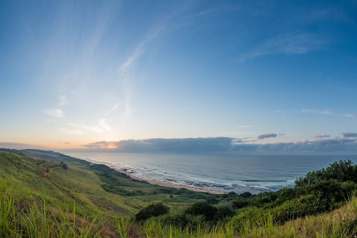 A panoramic view of the coastline and ocean from the elevated vacant land, showcasing natural landscape and horizon.
