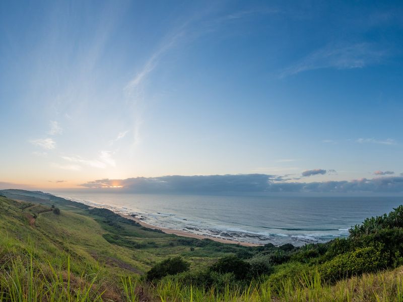 A panoramic view of the coastline and ocean from the elevated vacant land, showcasing natural landscape and horizon.