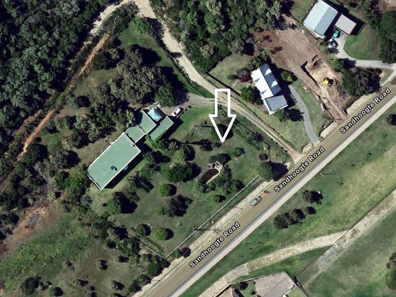 Aerial view of a residential vacant land plot featuring established trees and direct access to Sandhoogte Road.