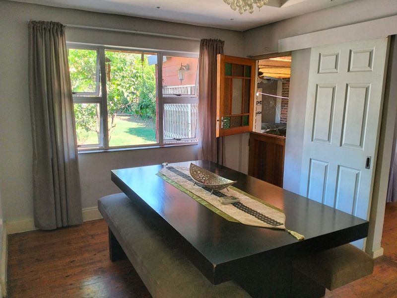 Dining room featuring hardwood flooring, recessed lighting, and access to the garden through a stable door and window.