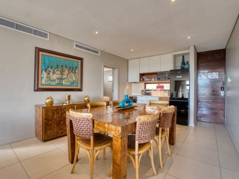 Open-plan dining and kitchen area featuring tiled floors, recessed lighting, ducted air conditioning, and modern built-in cabinetry.