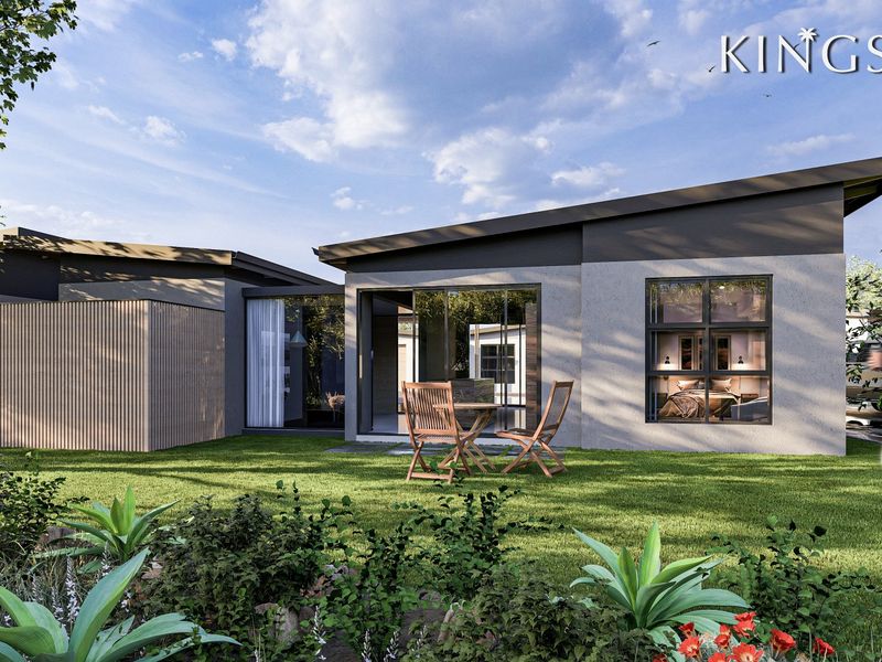 A modern architectural rear elevation featuring a skillion roof, timber slat detailing, and large sliding glass doors opening onto a landscaped garden.