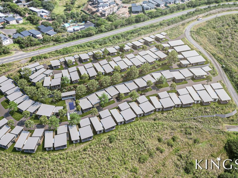 An aerial view of the Kingsley residential development, showcasing the layout of multiple housing units, communal pool area, and surrounding landscaped grounds.