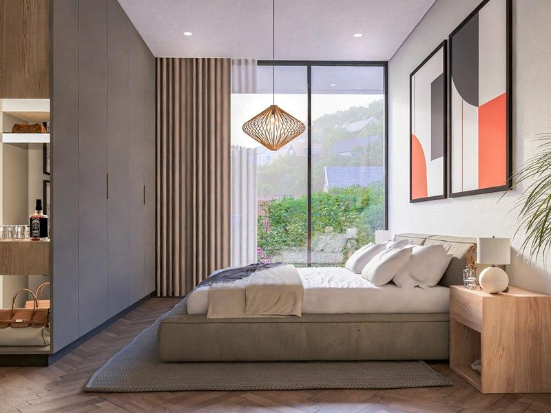 Modern bedroom featuring floor-to-ceiling built-in wardrobes, herringbone timber flooring, and large glass sliding doors opening to an outdoor view.