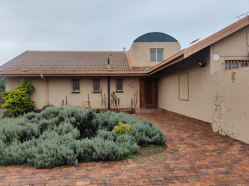 Front elevation of a single-story house featuring a tiled roof, brick paved entrance path, and security-fitted windows.