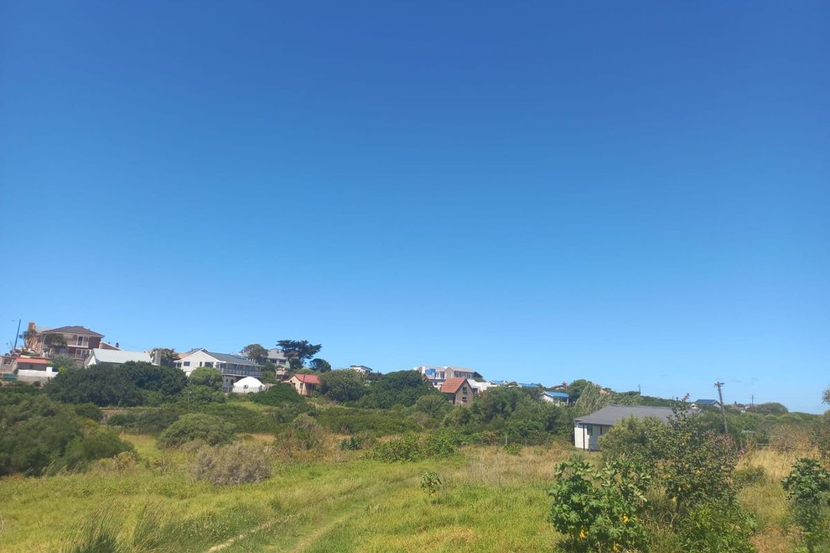 A scenic view of the surrounding landscape and neighboring properties, showcasing the natural terrain and open space of the farm area.